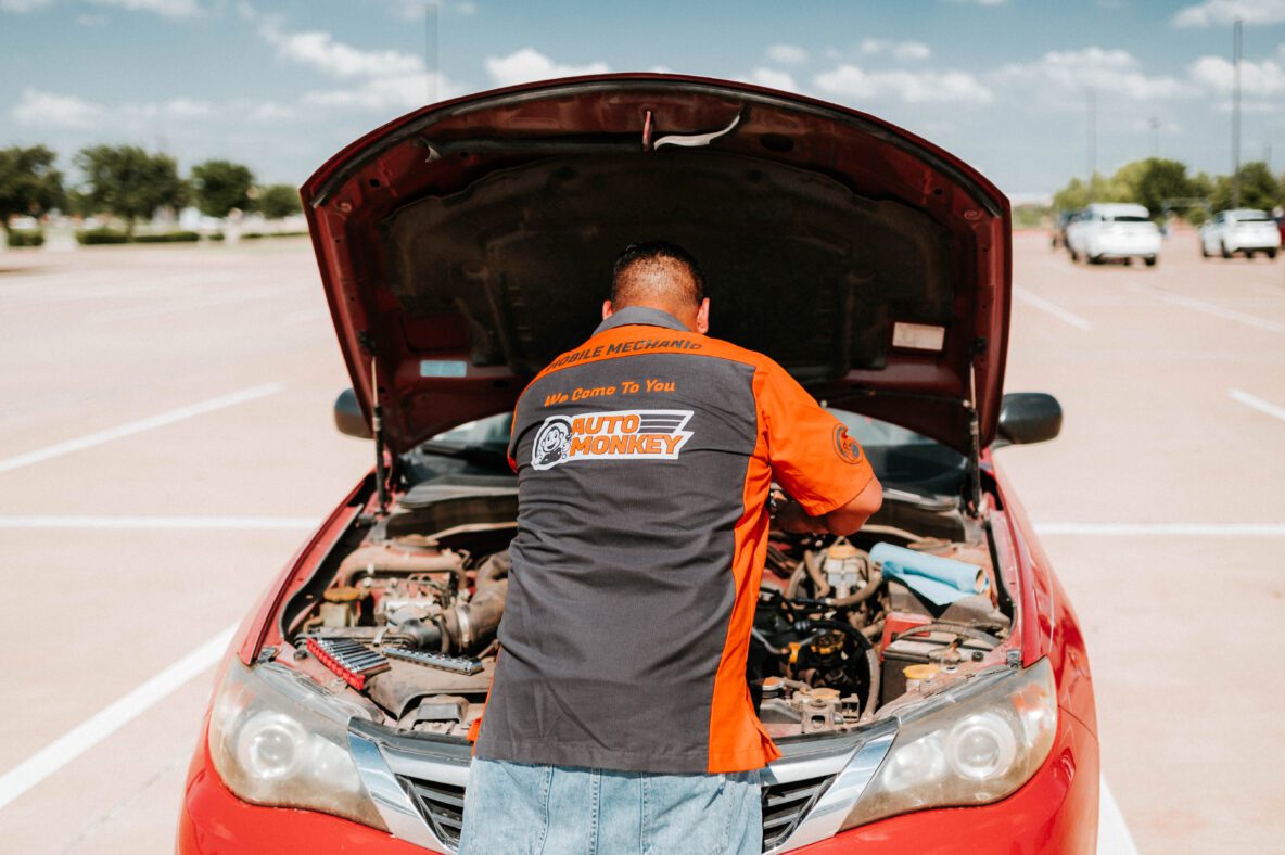 Auto Monkey mobile mechanic working on car in commercial parking lot